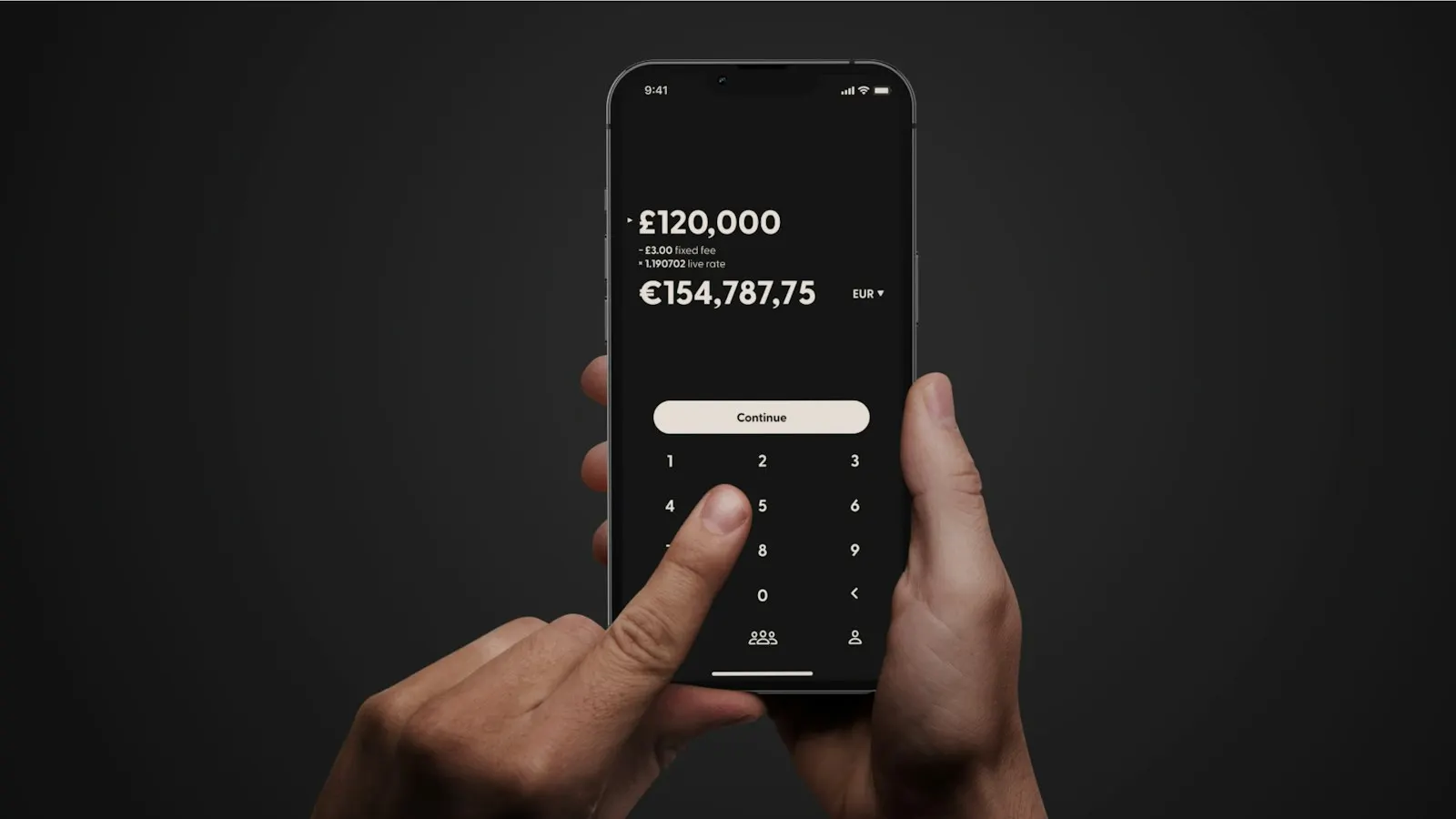 Hands holding a phone with a money transfer screen open